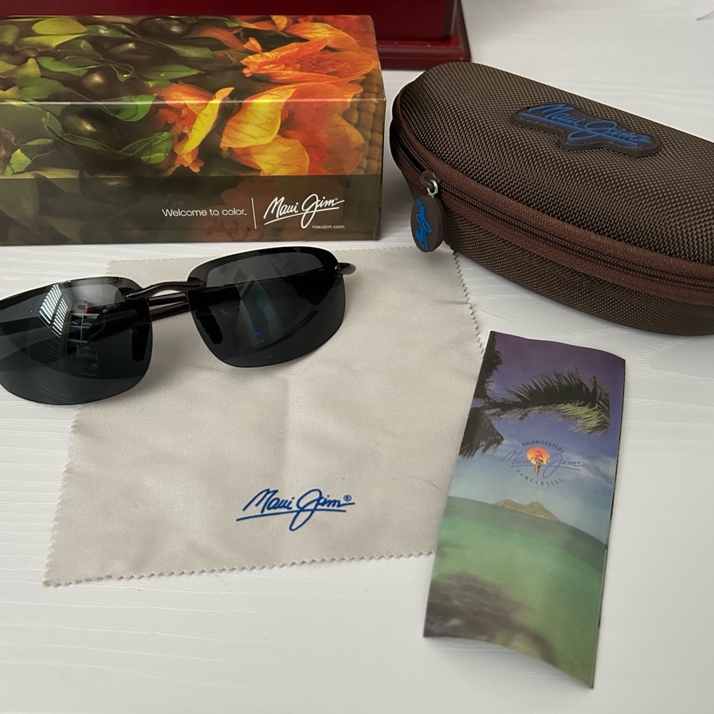 Brand new. Never worn. Maui Jim Brown and Black Sunglasses with case and cloth.